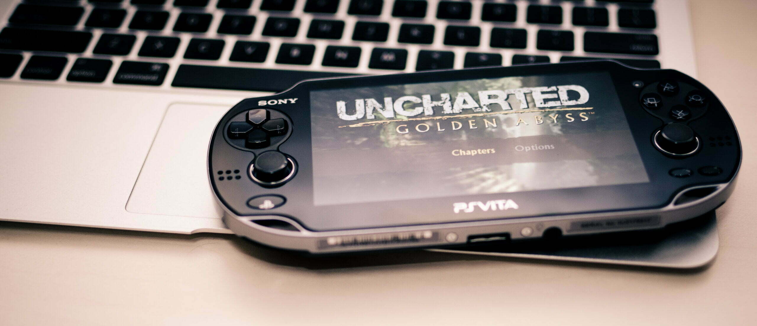 A black PlayStation Vita playing Uncharted